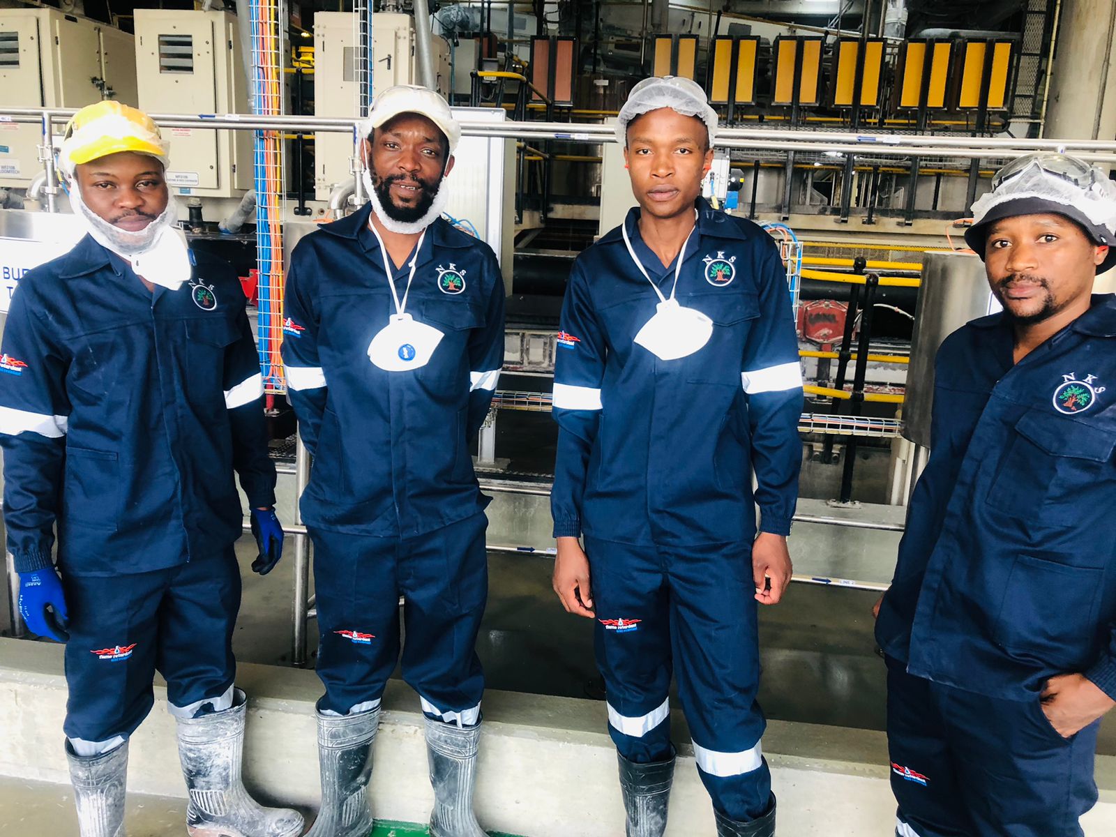 NKS Group team in branded uniforms on the factory floor